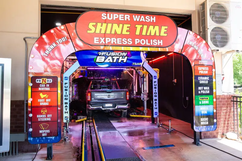 A freshly washed car leaving the Shine Time tunnel